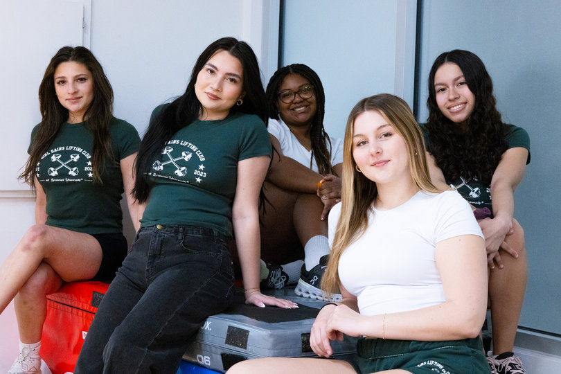 Syracuse University women’s fitness club, Girl Gains, pose in athleisure. The club aims to create a safe space and community for female gym-goers