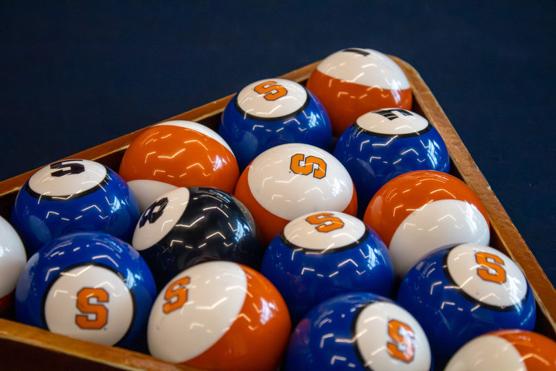 Billiard balls in the performance center showcase blue and orange colors, with the block “S” Syracuse logo. SU’s player lounge features a pool table, a retro NBA Jam arcade machine and more.