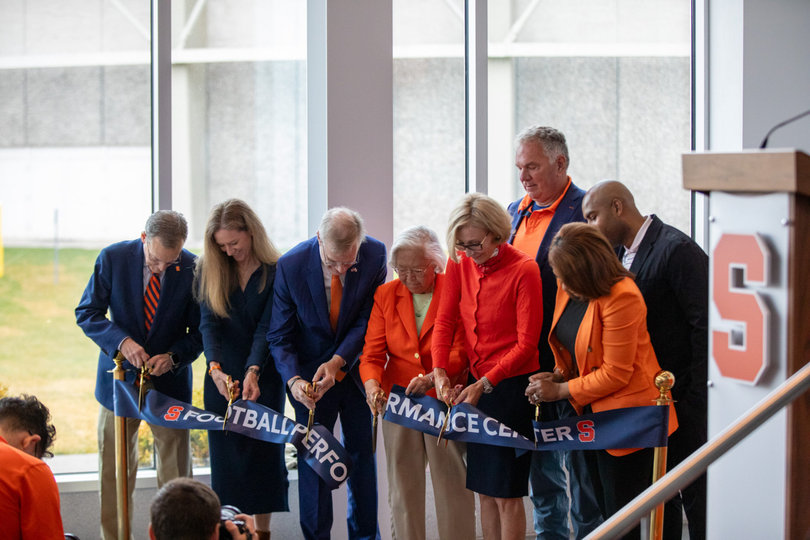 Syracuse’s brass of leaders simultaneously cut a ribbon to declare the official opening of its new football performance center. Director of Athletics John Wildhack (left) and Chancellor Kent Syverud (center), among others, were in attendance for the event. 
