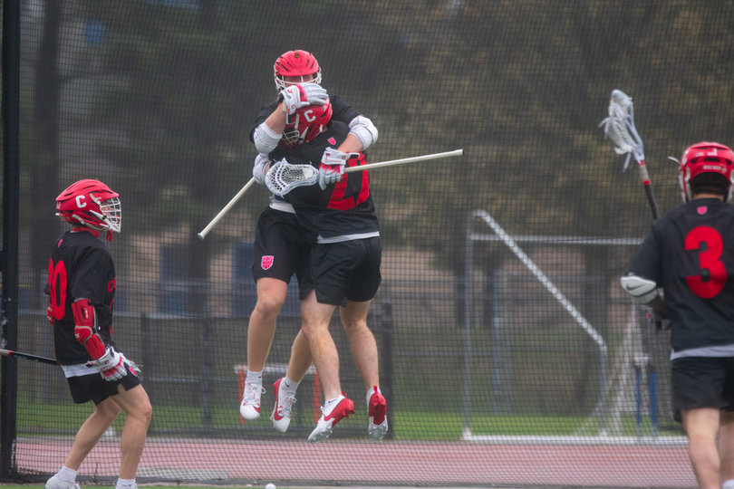 Cornell midfielder Hugh Kelleher (second-left) leaps in celebration to embrace attack CJ Kirst. The Big Red had reason to celebrate, as they built a six-goal first-half lead and didn’t let Syracuse get closer than within two goals the rest of the way.