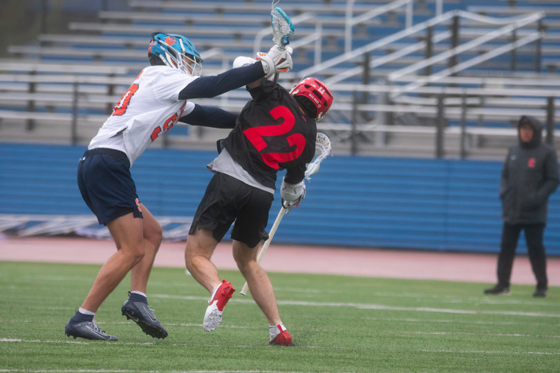Syracuse short-stick midfielder Ryan Ochoa (left) checks Cornell attack Brian Luzzi (No. 22). Saturday’s clash was a physical one with 15 penalties. The Big Red made the most of their man-up opportunities, going 4-for-7 to pace their win.