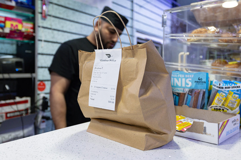An order sits ready for a late-night delivery driver’s run. The café’s 24-hour status makes it available on Marshall Street and around campus.