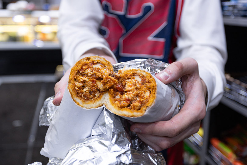 Jared Reinhard shows off his order for the night, a classic parmigiana. The sandwich was made with chicken cutlets, marinara sauce and fresh mozzarella.