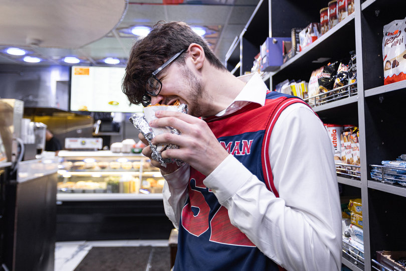 Reinhard wastes no time enjoying his classic parmigiana sandwich. Customers enjoy several of the café’s options fresh off the grill.