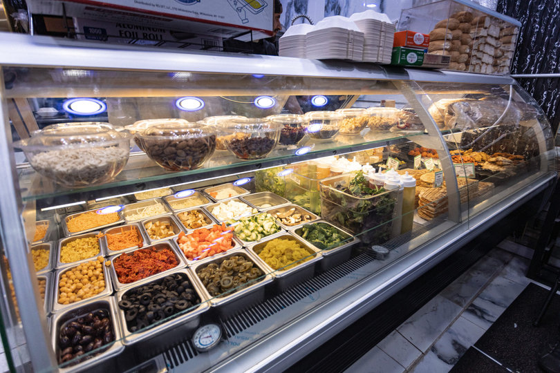 Fresh vegetables, meats and other ingredients lay ready for customers to customize their sandwiches. Cuse Gourmet Deli and Café serves sandwiches, wraps, salads, burritos, paninis and smoothies.