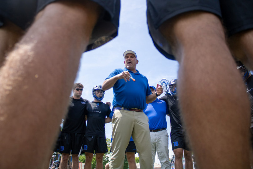 Duke assistant coach Ron Caputo relays instructions to his team in a huddle. Caputo, who works with the Blue Devils’ defense and faceoff units, led his defensive unit to an outstanding day as Duke held SU to seven goals — tied for the second-fewest in head coach Gary Gait’s four-year tenure.