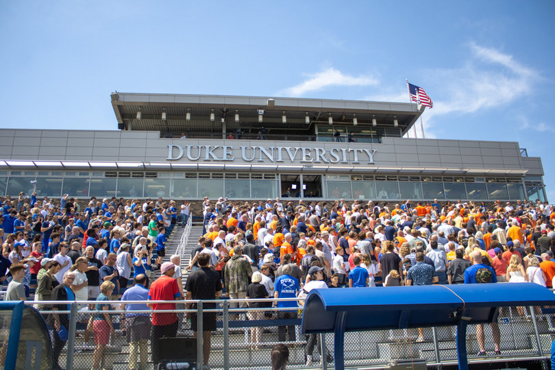 Syracuse and Duke fans stand for the National Anthem at Koskinen Stadium. Though the crowd was mixed with fans from both sides, the Blue Devils’ cheering section came away happy after Duke pulled out an 11-7 win.