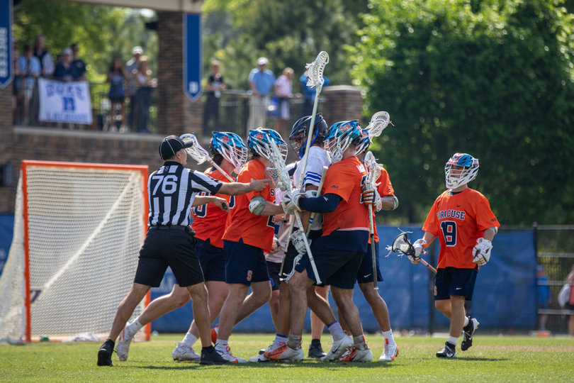 As the game concludes, Duke’s Max Sloat (white jersey) becomes engulfed by numerous Orange players. In the final moments, as a second straight loss loomed, SU’s temper became frayed and produced a heated finish.