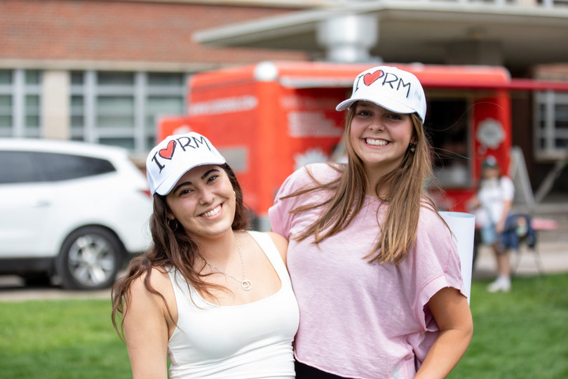 Two students take advantage of the free airbrush hat station to celebrate Role Model’s Block Party performance. Students enjoyed plenty of activities at Block Darty before the concert began.