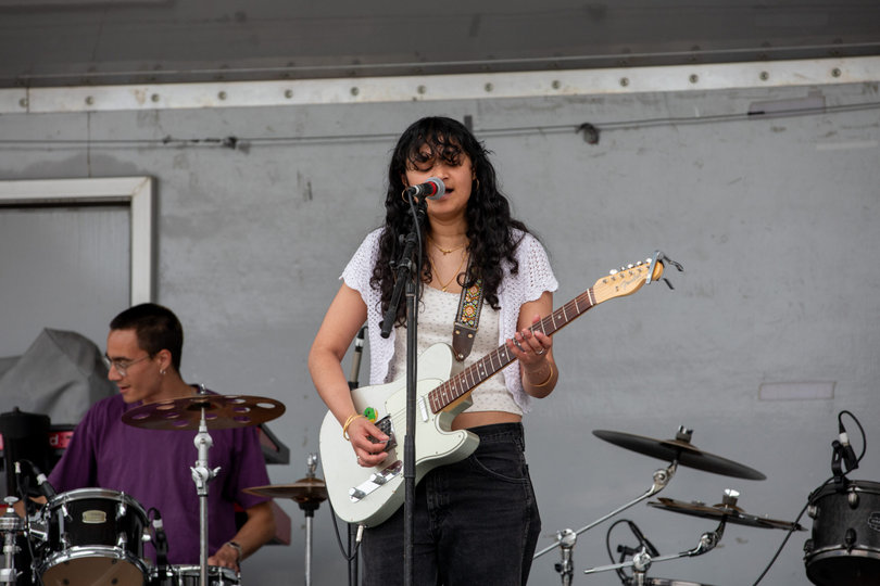 Student performer Padma opens Block Darty before Alex Vaughn and Sun Room play. Padma performed songs by artists like Sabrina Carpenter as well as her own original songs.