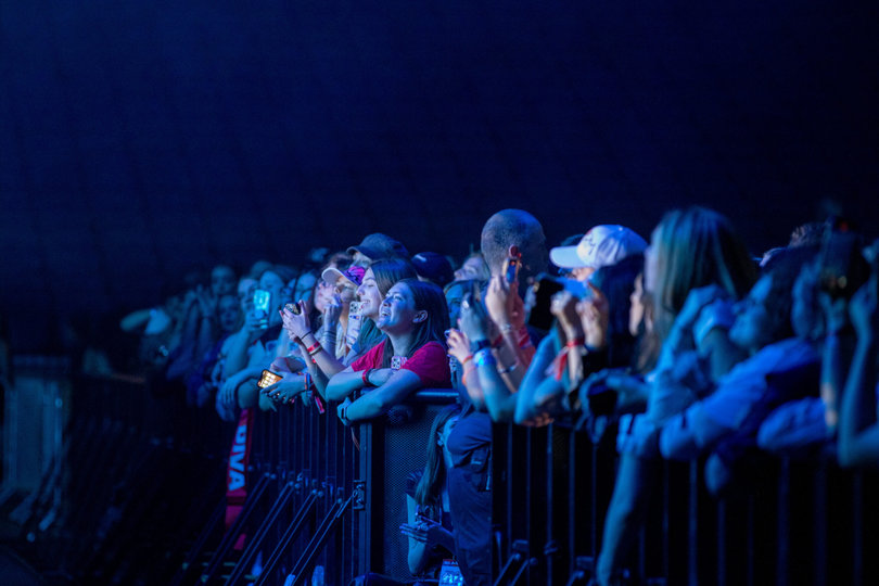 Fans gather against the barricade as Role Model gets ready to perform. Students took the opportunity to film and photograph the concert on their own phones.