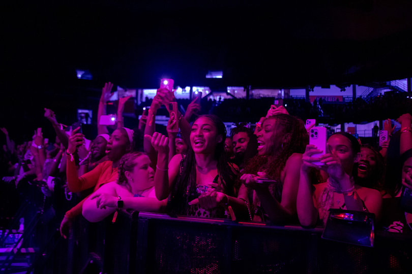 Audience members look on as Latto gives away gifts during her performance. One student received $1,000 and another received a pair of Givenchy boots. 