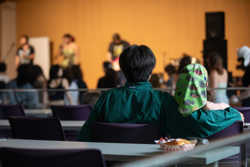 A couple sits back and enjoys the live music from the back of Marshall Hall. Students enjoyed the show from their seats and from the dance floor.