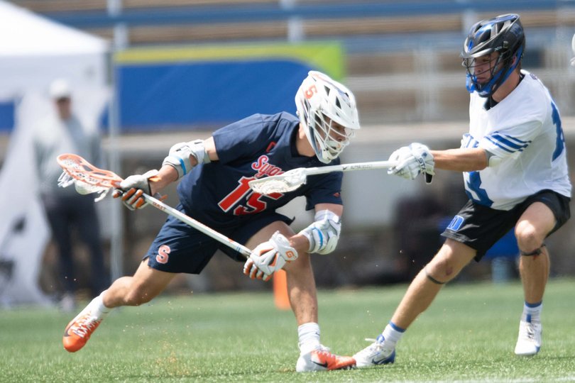 Sam English cradles the ball against a Duke defender. Versus the Blue Devils, English was held without a point for the first time all season. 