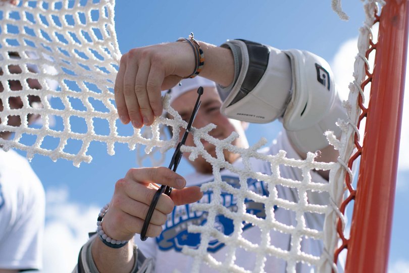 A Syracuse player cuts down the nets after SU’s ACC Tournament victory over Duke. The Orange will now face Harvard in the first round of the NCAA Tournament.
