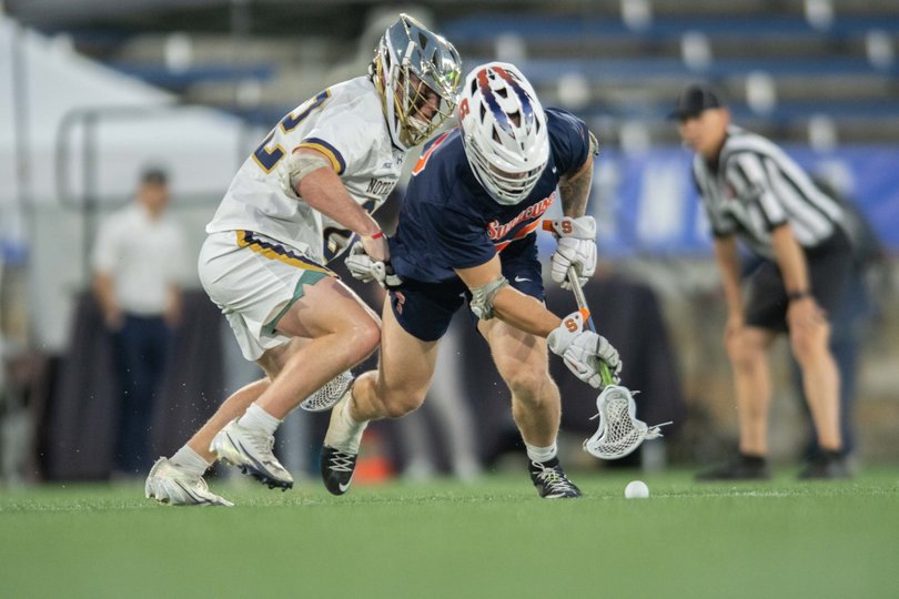 John Mullen battles against Notre Dame faceoff specialist Will Lynch. Mullen won 21 out of his 26 faceoff attempts in SU’s 14-12 semifinal win over the Fighting Irish.