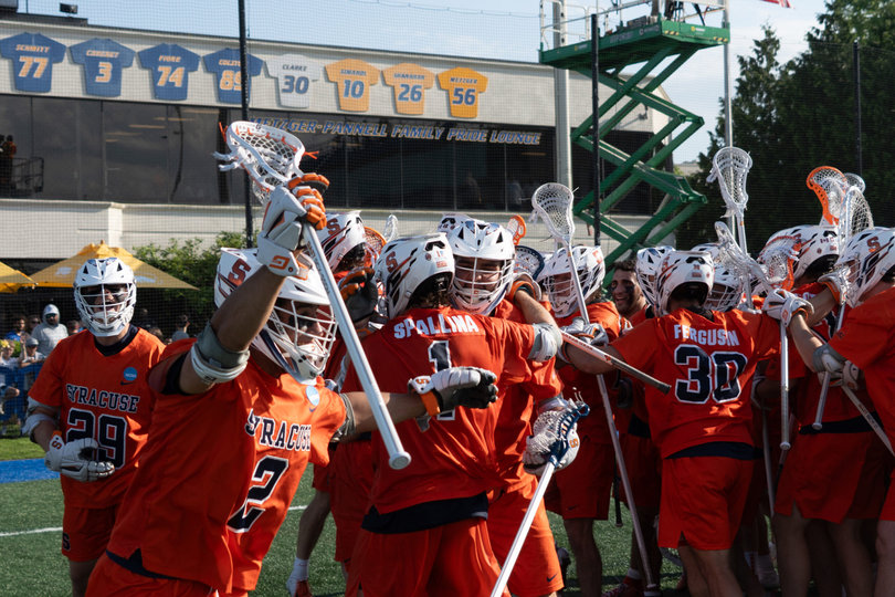 Vincent Bolognino (No. 2) waves his arms in the air in celebration while Jake Spallina (No. 1) hugs a teammate after Syracuse’s defeat of Princeton. SU’s last 12 years included four NCAA Quarterfinal exits and four first-round knockouts, but its victory Saturday ended that drought.