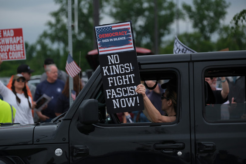 SYRACUSE, NY — Cars drive through Solar Street as other protesters line the sidewalks. People held signs promoting democracy and denouncing fascism. 
