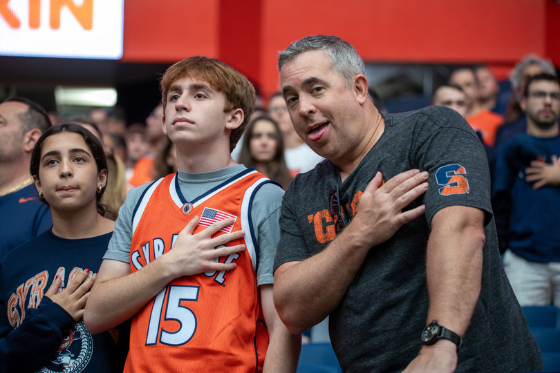 Orange fans stand for the national anthem before football’s noon kickoff. Parents and their children shared cheers, laughs and funny faces during this weekend’s events.