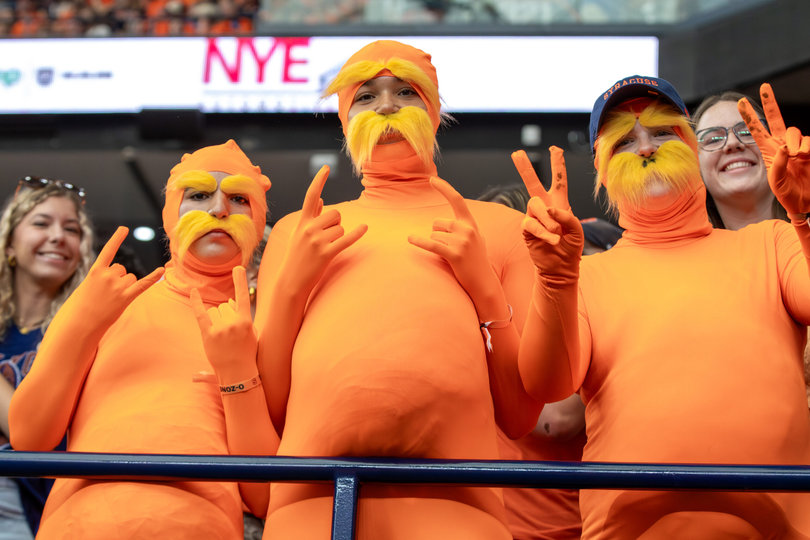 Three students dressed as the Lorax stand in the front row of Otto’s Army. The student section was a sea of orange as football fell 38-3 to the Blue Devils.