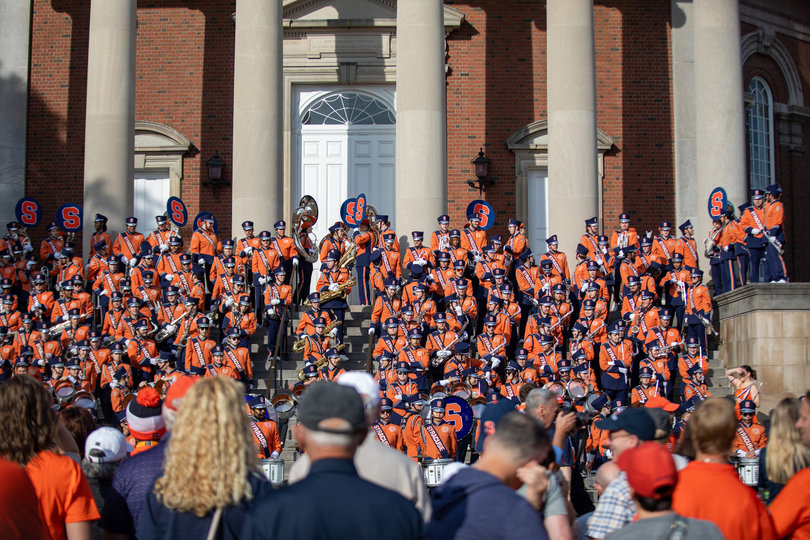 Hundreds of fans, students and parents wait for the Orange to arrive. Spectators listened to the band as they played music from the steps of Hendricks Chapel both before and during the team’s walkout.