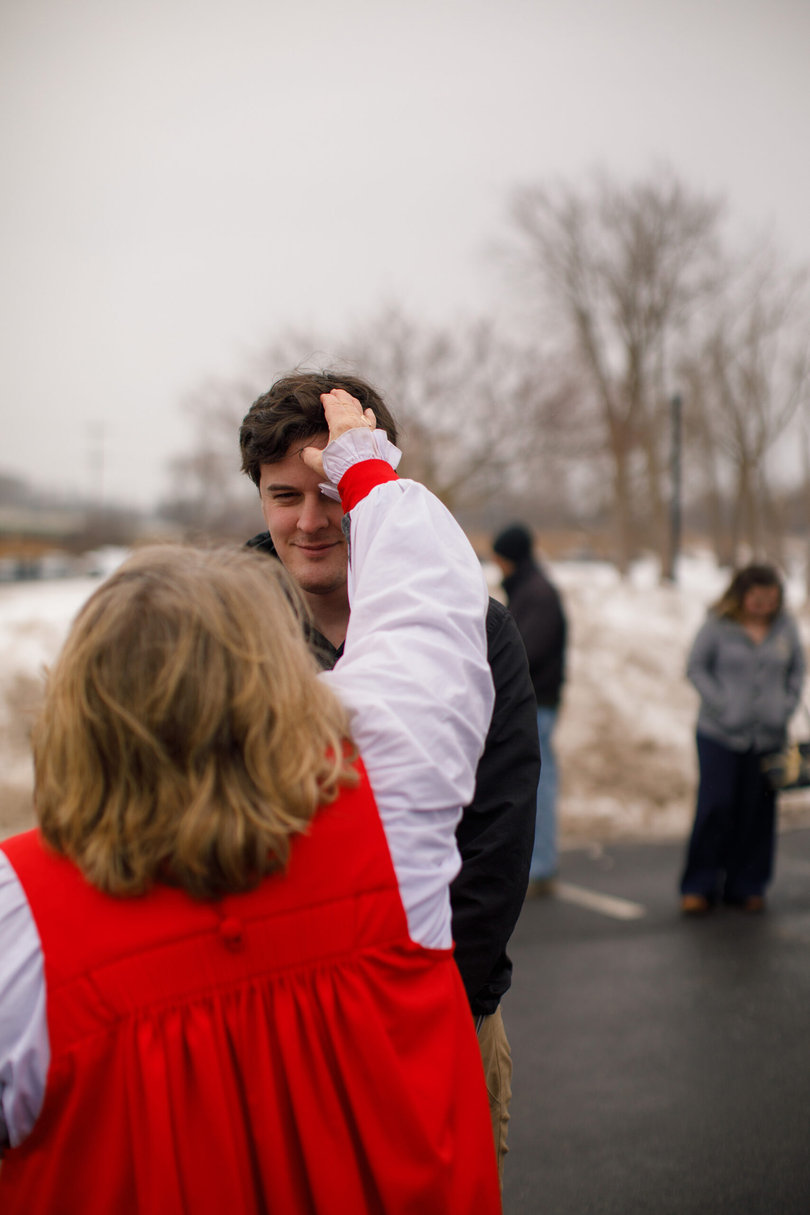 Bishop places ashes on the forehead of a parishioner.