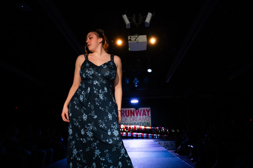 InclusiveU student Nicole Massab walks in Syracuse University’s Runway of Dreams fashion show on Sunday. Her mom cheered her on. 

