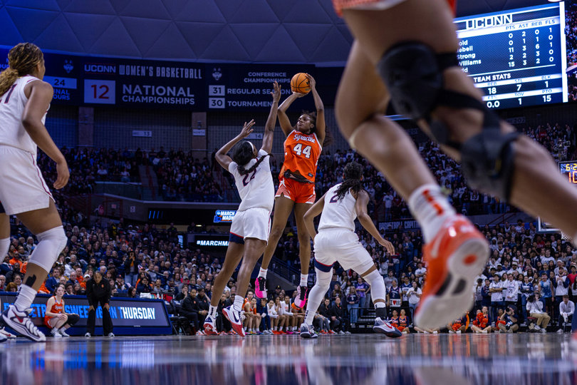 Uche Izoje rises for a mid-range jump shot over 6-foot-4 forward Serah Williams. Izoje scored 12 points in Syracuse’s season-ending loss to UConn.