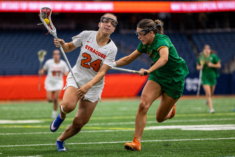 Syracuse attack Caroline Trinkaus (left) carries the lacrosse ball in her stick. The sophomore applied the coup de grâce to the Fighting Irish, cannoning a ball into the roof of the net as time expired in the fourth overtime period. 
