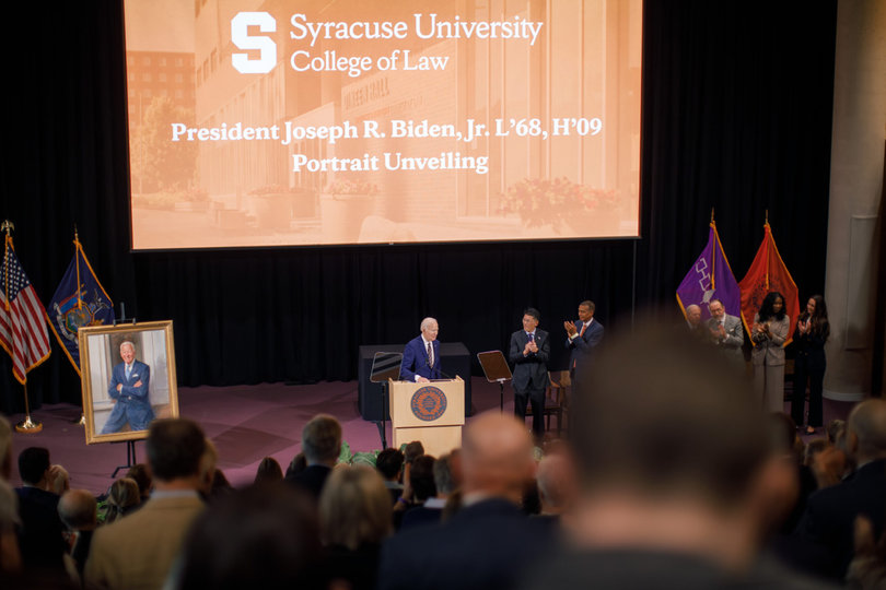Biden accepts a standing ovation as he takes the podium for his remarks. Tuesday marked Biden’s first appearance at Syracuse University in a decade.