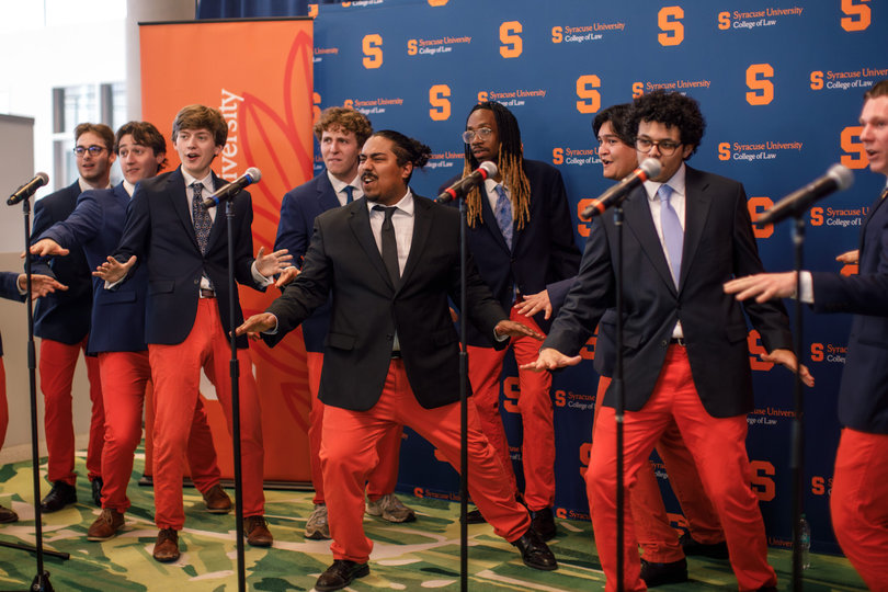 The Ottotunes, Syracuse’s orange pants-wearing a cappella group, dance at the ceremony’s reception. The group sang “America the Beautiful” during their set.