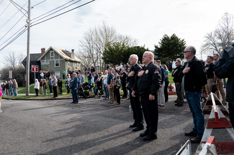 Before the statue’s unveiling, attendees of the ceremony sing the national anthem. Representatives from both the SPD and Onondaga County Sheriff’s Office attended.