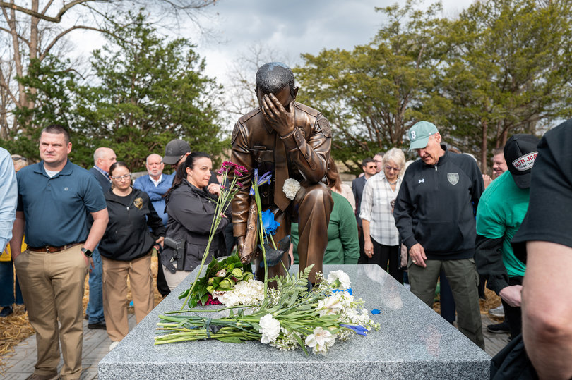 The Syracuse Police Department unveils a monument depicting an officer kneeling atop the American flag, which honors officer Michael Jensen and lieutenant Michael Hoosock two years after their death. The two officers were fatally shot following an escalated routine traffic stop in April 2024.
