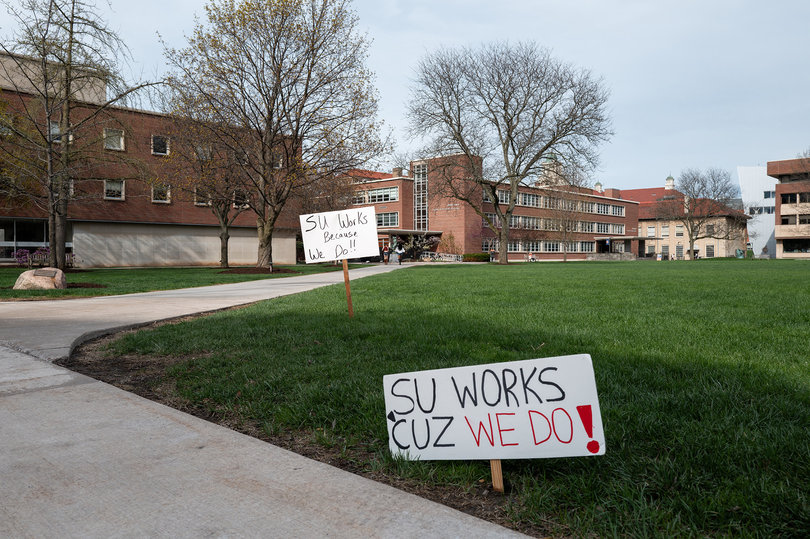 Signs on SU's quad that say "SU works because we do!"
