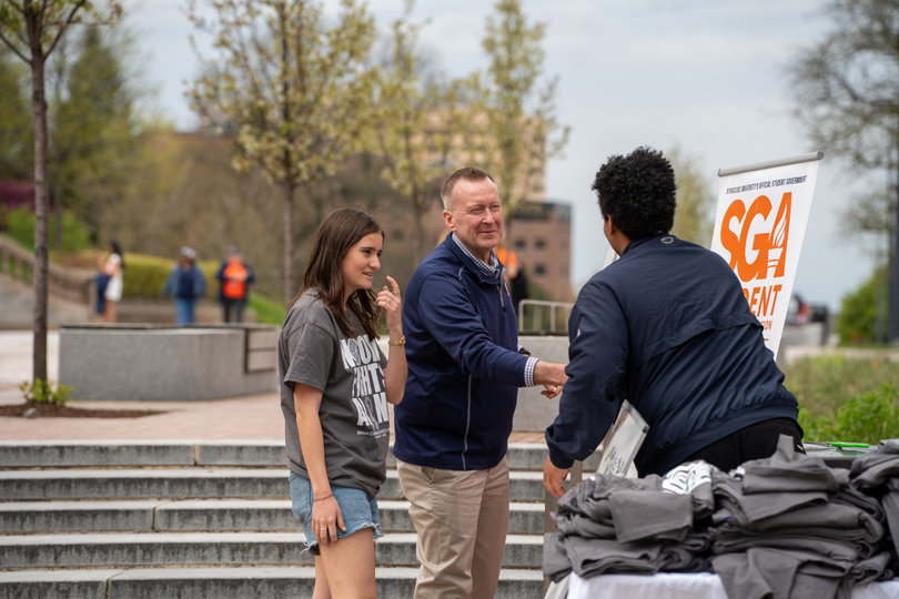 Acting SU Chancellor Mike Haynie shows his support at Tuesday’s event. During the first 30 minutes, Haynie greeted students, sat behind the snack booth and handed pins to visitors.