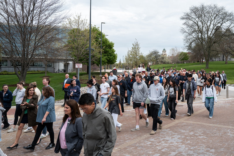 Members of the campus community walk across Crouse Drive to reach a small stage set up in front of Crouse-Hinds Hall, where scheduled speeches were set to begin. Though Syverud is already in Michigan receiving treatment, the event was held outside the building that holds the chancellor’s office.