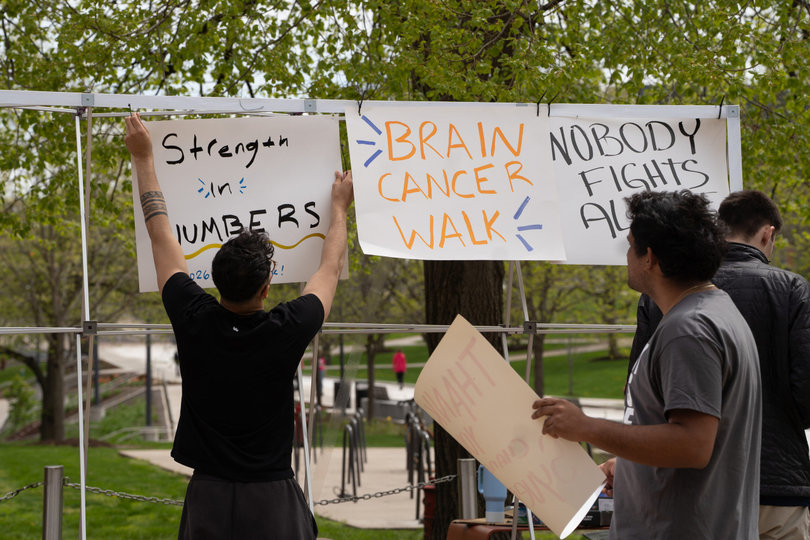 SGA members hang signs to encourage Syverud on his journey to recovery. They eventually moved the display to the wall after the wind kept knocking the small structure over.