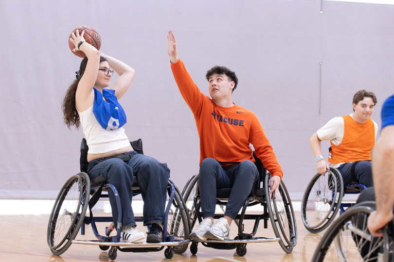 Students participate in wheelchair basketball as a part of an event held during Syracuse University’s disability pride month. Syracuse holds these games to celebrate people embracing their full identities.