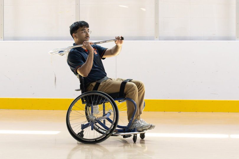Participant Gunjan Siwal gears up to pass the ball to a teammate during the wheelchair lacrosse game. Syracuse holds these events in April to align with the academic calendar for maximum participation.