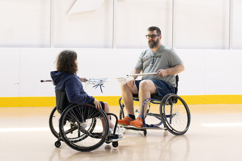 Two teammates toss a lacrosse ball back and forth to practice their stick skills before the game. Participants came for a few reasons — interest in the cause, philanthropy and class participation.