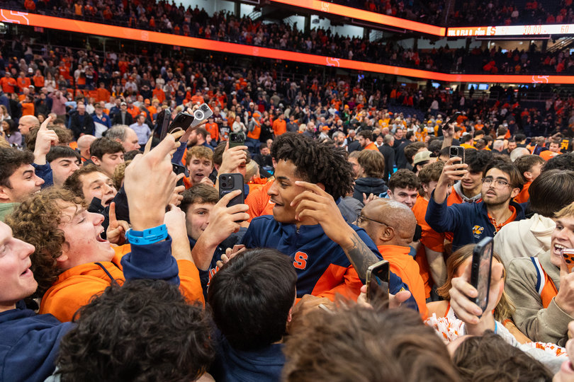 December 2, 2025: Syracuse men’s basketball fans surround SU guard Kiyan Anthony on the JMA Wireless Dome floor after the Orange upset then-No. 13 Tennessee 62-60. The win was Syracuse’s lone Quad 1 victory of the season.