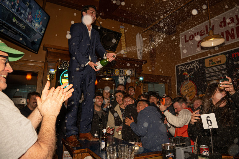 May 3, 2026: SU senior Jake Warcaba pops open a champagne bottle at Faegan’s Cafe & Pub’s annual Senior Blow-Out. This year, Warcaba delivered a speech.