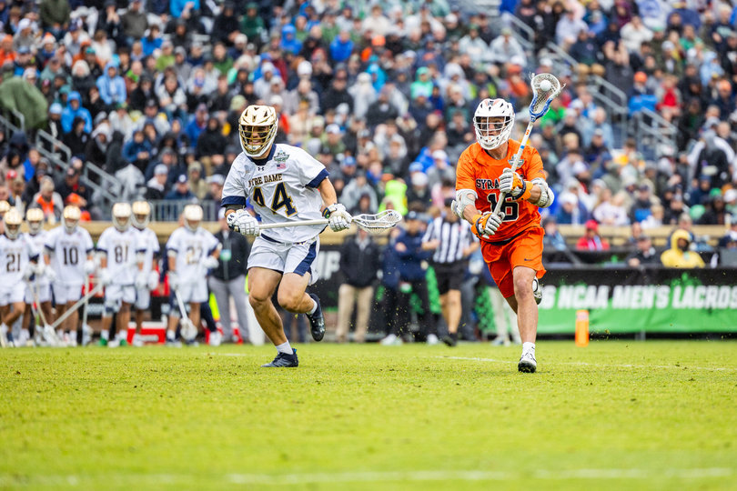 Syracuse midfielder Bogue Hahn looks to pass upfield as Notre Dame midfielder Kyle Bergen chases him. Hahn couldn’t provide the Orange an offensive spark, finishing with zero points on one shot.