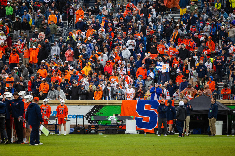 A large group of Syracuse supporters rises behind SU’s sideline at Scott Stadium, the host of the Final Four. Saturday’s game drew a crowd of 24,396 people.