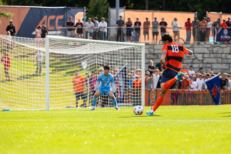 Jordan Grey winds up to shoot in Syracuse's loss to New Hampshire Sunday. Grey has been a welcome addition to SU thus far, recording two goals and one assist in its first two games.