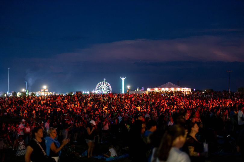 Attendees of the Great New York State Fair gather under red stage lights. Catch the Total Chaos Rodeo Drill Team or a "Shrek"-themed rave at the NYS Fair this week.