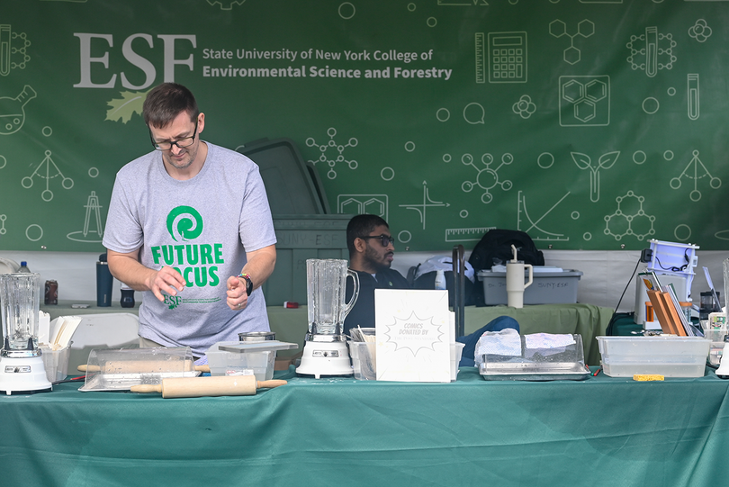 The SUNY ESF booth showcased student work at the Great New York State Fair. An alternative to plastic wrap made from sugar maple tree shavings was displayed.