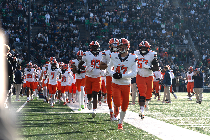 Syracuse football trots onto the field at Notre Dame Stadium before the sides' matchup on Nov. 22, 2025. The Orange take the JMA Wireless Dome field on Sept. 5 when they open the season against New Hampshire.