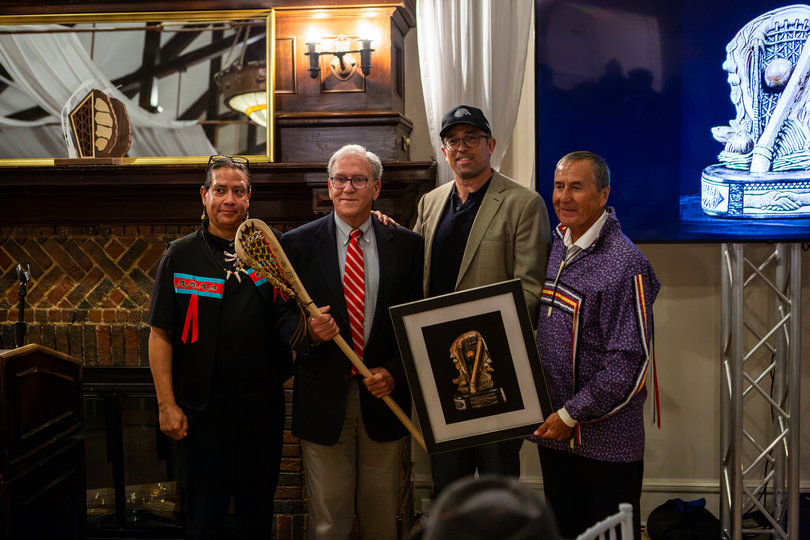 Dom Starsia (second from left) accepts one of three Alfie Jacques Ambassador Awards. Starsia, Michael Kennedy and Mike Kanatakeron Mitchell were honored for their dedication and energy in growing lacrosse.
