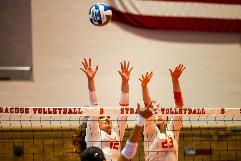 Syracuse volleyball’s Keila Gabriel (12) and Abby Nicholson (23) rise for a block during SU’s win over FDU on Sept. 18. The two have helped the Orange to a 5-4 record, with ACC play starting Friday.
